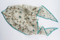 Sage triangle headscarf with teal floral vines and a green satin edge
