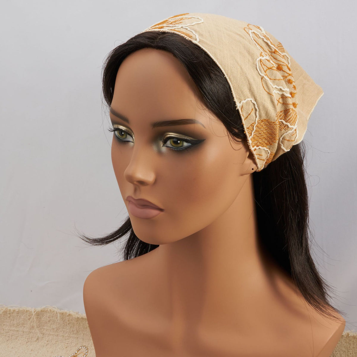 Camel triangle headscarf with rust floral embroidery and a gathered elastic back
