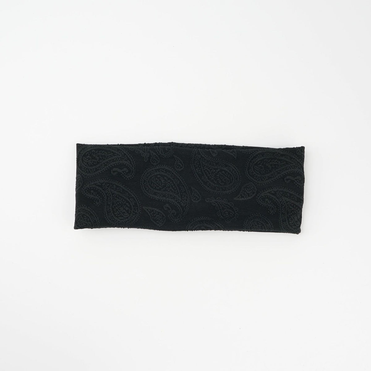 Wide knit headbands with a raised paisley pattern in ivory, coffee, and black